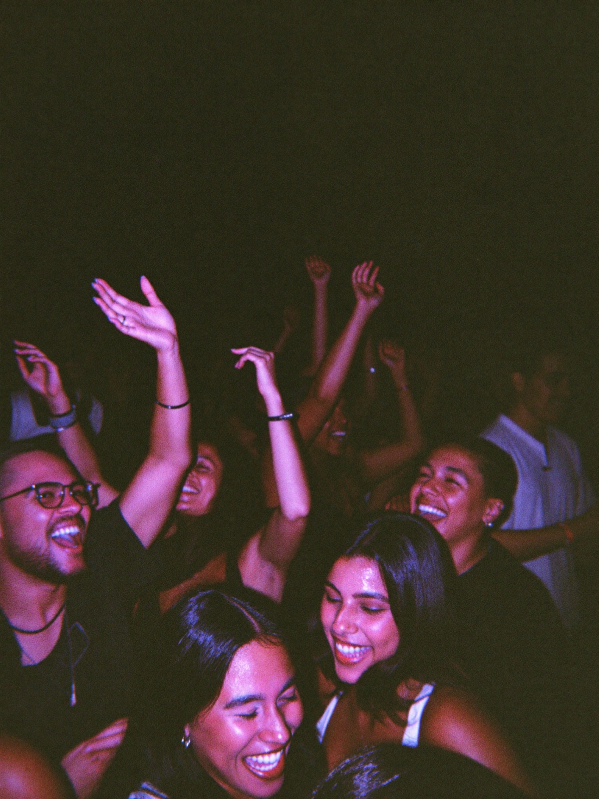 Crowd dancing with arms up