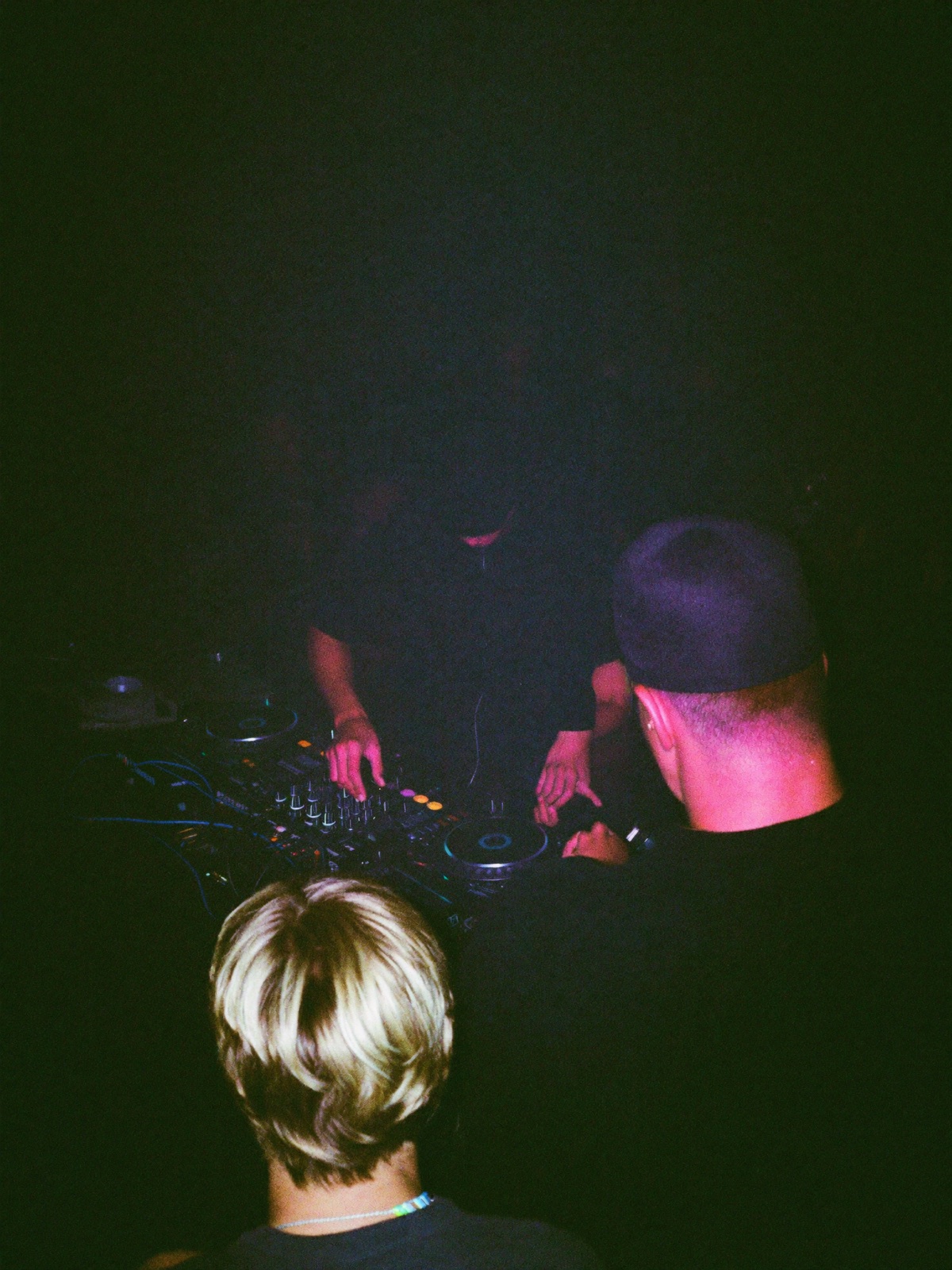 DJ playing behind the booth